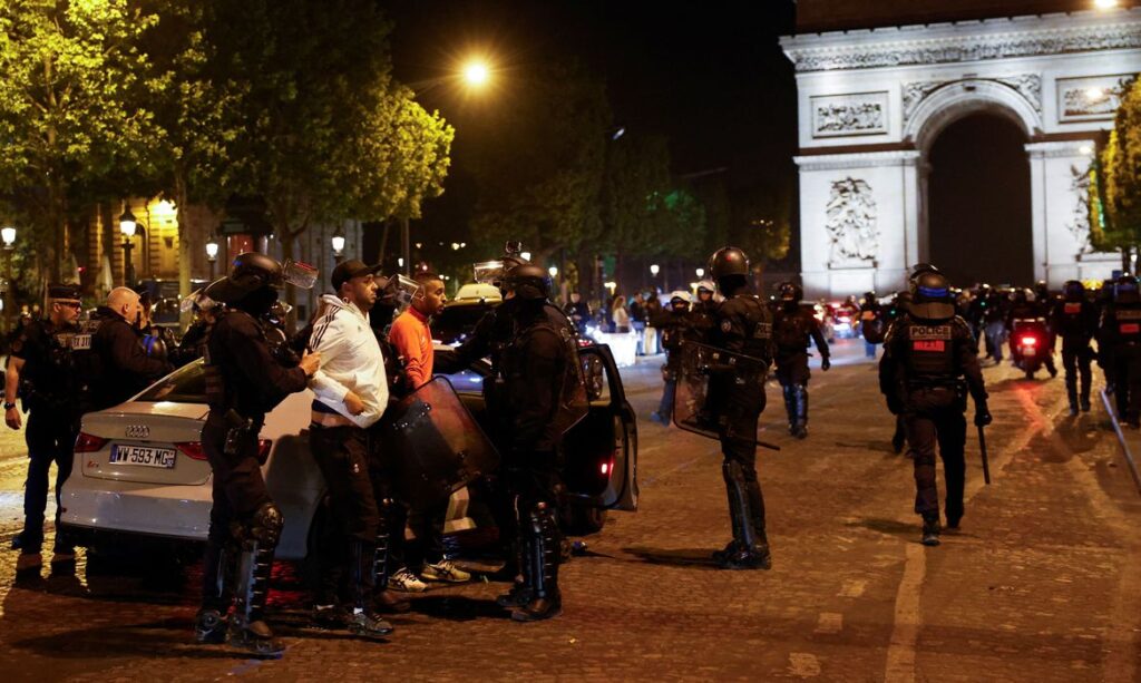 Police detain young people during the fifth night of protests following the death of Nahel, a 17-year-old teenager killed by a French police officer in Nanterre during a traffic stop, in the Champs Elysees area, in Paris, France, July 2, 2023. REUTERS/Juan Medina