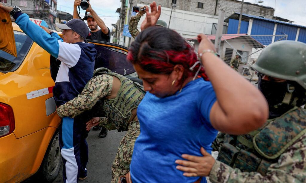 Soldiers inspect local residents while patrolling in a commercial area, in the aftermath of a wave a violence that saw the storming of a TV station on-air and explosions around the nation, in Guayaquil, Ecuador, January 11, 2024. REUTERS/Ivan Alvarado