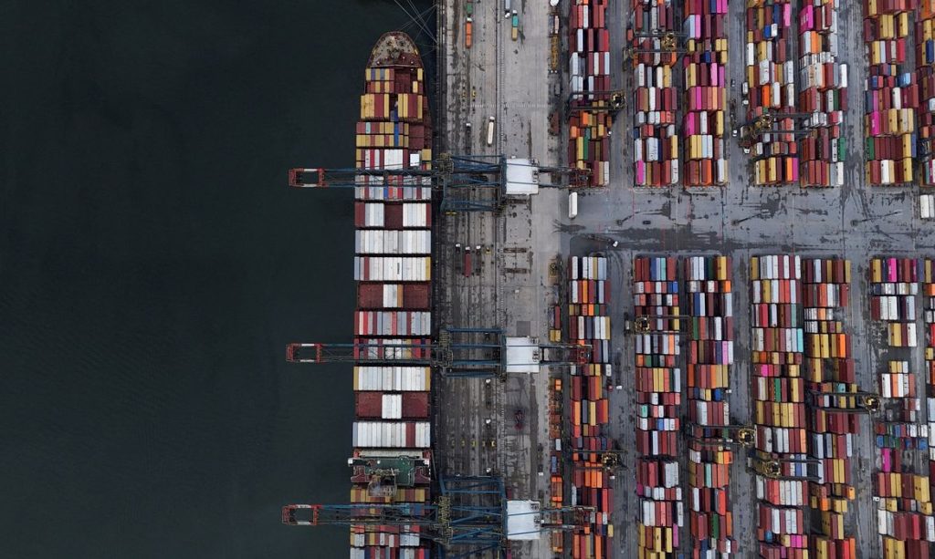 FILE PHOTO: A drone view shows a ship and containers at the Port of Santos, in Santos, Brazil April 3, 2025. REUTERS/Amanda Perobelli/Proibida reprodução