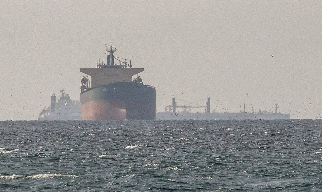 FILE PHOTO: Cargo ships in the Gulf, near the Strait of Hormuz, as seen from northern Ras al-Khaimah, near the border with Oman’s Musandam governance, amid the U.S.-Israeli conflict with Iran, in United Arab Emirates, March 11, 2026. REUTERS/Stringer//File Photo