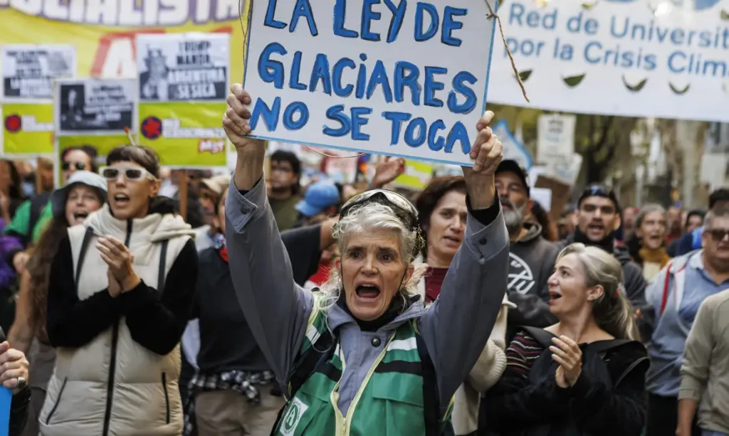 A woman marches toward the National Congress as lawmakers debate a reform to the Glaciers Law in Buenos Aires, Argentina, on April 8, 2026. The reform, promoted by Argentine President Javier Milei, seeks to allow provinces to define glacier protection zones to permit the expansion of mining activity. (Photo by Matias Baglietto/NurPhoto)NO USE FRANCE