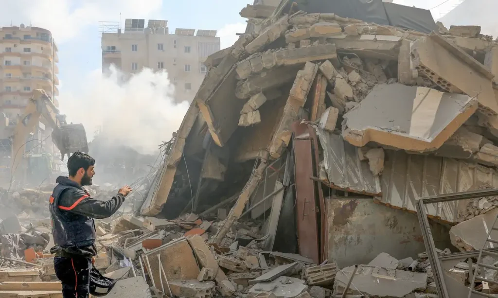 A rescuer stands next to a pile of rubble at the site of an Israeli strike in Tyre, Lebanon, April 8, 2026. REUTERS/Adnan Abidi