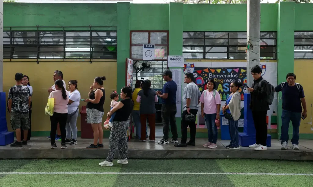 People queue to vote at a polling station after Peru's general election was extended to a second day in some precincts of the capital due to the late setup of voting tables and the absence of citizens assigned to receive voters, in Lima, Peru, April 13, 2026. REUTERS/Manuel Orbegozo