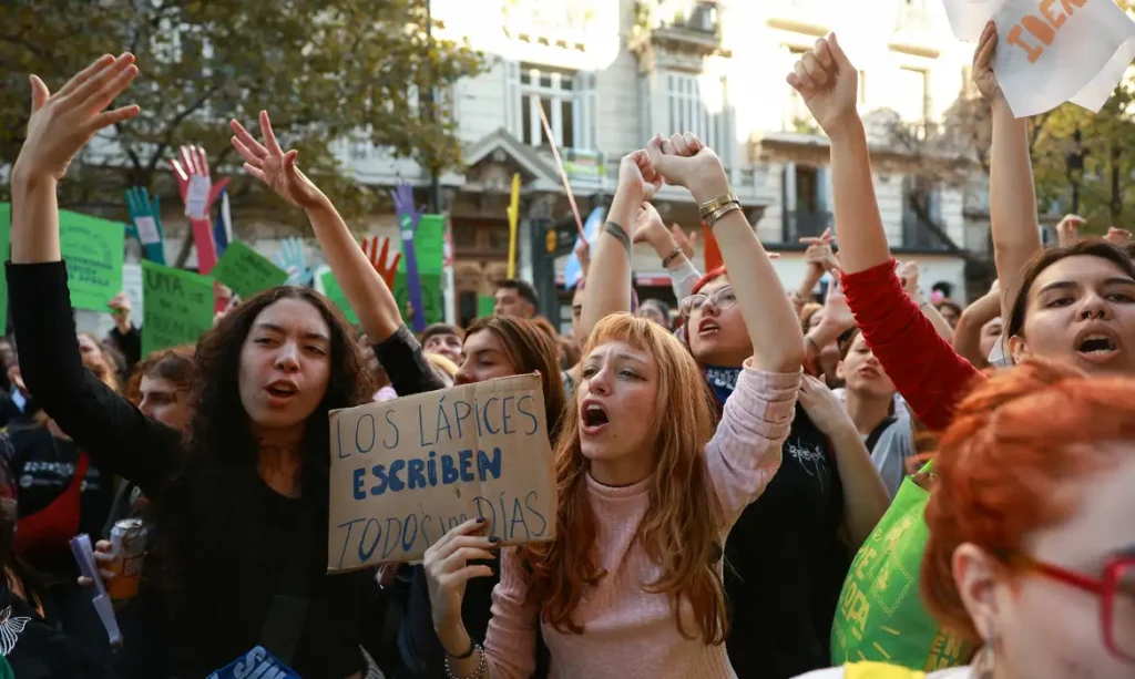 A demonstrator holds a sign that reads