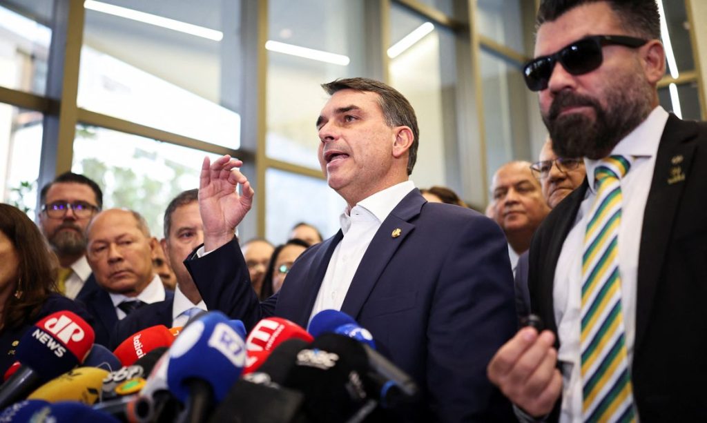 Flavio Bolsonaro speaks with members of the press after a meeting, following a scandal over messages tied to his request for funding for a biopic about former Brazilian President Jair Bolsonaro, from disgraced banker Daniel Vorcaro, who was arrested in March on suspicion of leading a multibillion-dollar fraud scheme, in Brasilia, Brazil, May 19, 2026. REUTERS/Mateus Bonomi