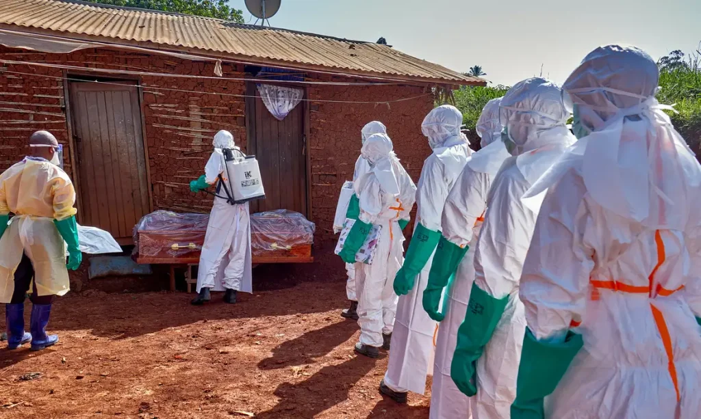 Red Cross workers wearing personal protective equipment (PPE) disinfect the house of an unidentified man who died of Ebola before retrieving his body, as aid agencies intensify efforts to contain a new Ebola outbreak involving the Bundibugyo strain, in Quartier Shuni 1, a residential sector in Mongbwalu, Djugu Territory of Ituri province, Democratic Republic of Congo, May 24, 2026. REUTERS/Gradel Muyisa Mumbere     TPX IMAGES OF THE DAY