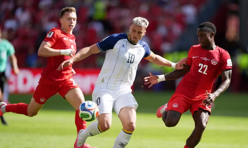 Soccer Football - FIFA World Cup 2026 - Group B - Canada v Bosnia and Herzegovina - Toronto Stadium, Toronto, Canada - June 12, 2026 Bosnia and Herzegovina's Ermedin Demirovic in action with Canada's Richie Laryea and Alistair Johnston IMAGN IMAGES via Reuters/John Sokolowski