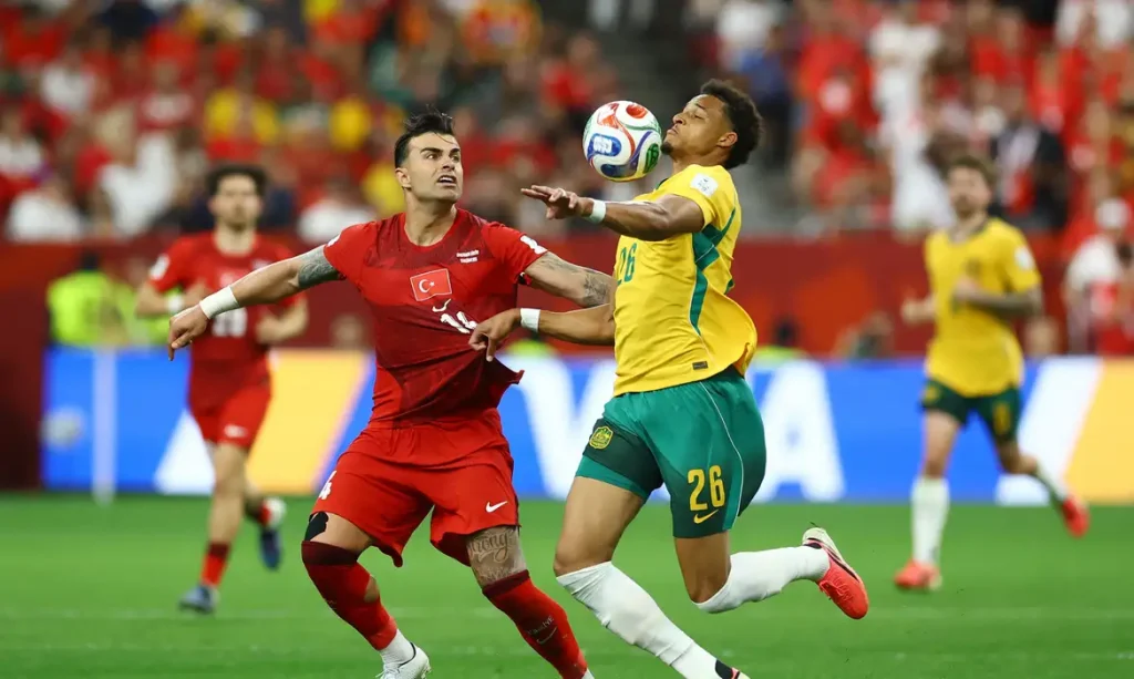 Soccer Football - FIFA World Cup 2026 - Group D - Australia v Turkey - BC Place, Vancouver, Canada - June 13, 2026 Australia's Tete Yengi in action with Turkey's Abdulkerim Bardakci REUTERS/Albert Gea