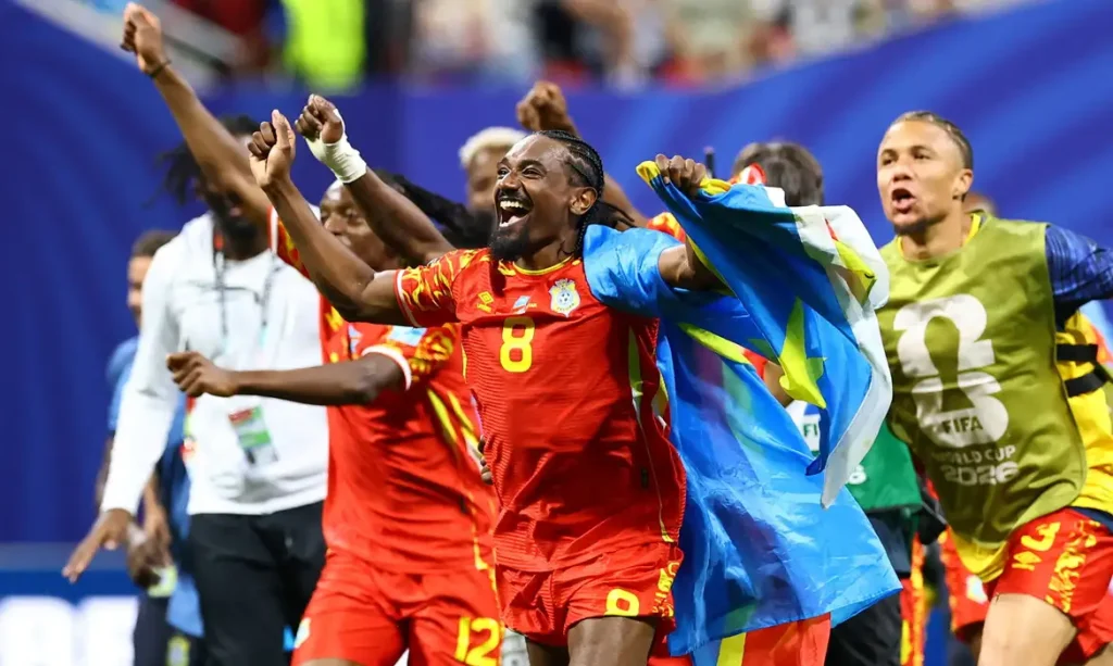Soccer Football - FIFA World Cup 2026 - Group K - DR Congo v Uzbekistan - Atlanta Stadium, Atlanta, Georgia, U.S. - June 27, 2026 DR Congo's Samuel Moutoussamy celebrates with their national flag after the match as they qualify for the knockout stages of the World Cup REUTERS/Bernadett Szabo     TPX IMAGES OF THE DAY