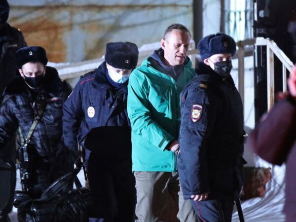 Russian opposition leader Alexei Navalny is escorted by police officers after a court hearing, in Khimki