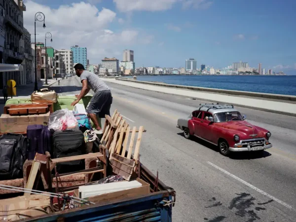 A man loads a truck with furniture to be relocated prior to the arrival of Storm Elsa, in Havana, Cuba, July 4, 2021. REUTERS/Alexandre Meneghini