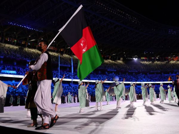 Tokyo 2020 Olympics - The Tokyo 2020 Olympics Opening Ceremony - Olympic Stadium, Tokyo, Japan - July 23, 2021. Flag bearers Kimia Yousofi of Afghanistan and Farzad Mansouri of Afghanistan lead their contingent during the athletes' parade at the opening ceremony REUTERS/Kai Pfaffenbach