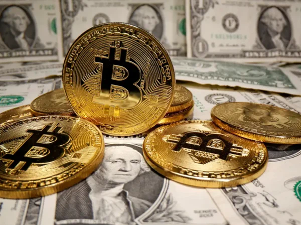 FILE PHOTO: Representations of virtual currency Bitcoin are placed on U.S. Dollar banknotes