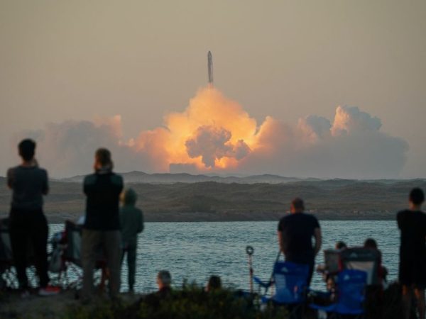 People watch as SpaceX's next-generation Starship spacecraft atop its powerful Super Heavy rocket lifts off from the company's Boca Chica launchpad on an uncrewed test flight, as seen from South Padre Island, near Brownsville, Texas, U.S. November 18, 2023. REUTERS/Go Nakamura