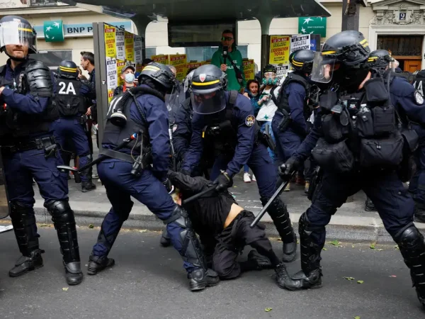 Riot police gather around a demonstrator who is being held on the ground during the traditional May Day labour union march in Paris, France, May 1, 2024. REUTERS/Sarah Meyssonnier