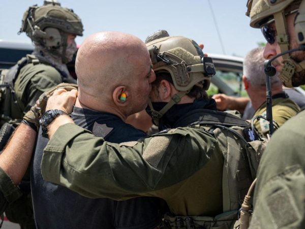 Shlomi Ziv, speaks with an Israeli soldier, after the military said that Israeli forces have rescued four hostages alive from the central Gaza Strip, in Ramat Gan, Israel, in this handout image obtained by Reuters on June 8, 2024. Israeli Army/Handout via Reuters  THIS IMAGE HAS BEEN SUPPLIED BY A THIRD PARTY