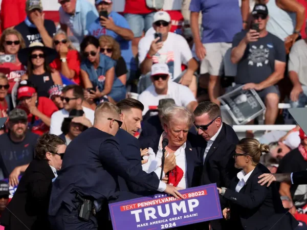 Republican presidential candidate and former U.S. President Donald Trump is assisted by U.S. Secret Service personnel after gunfire rang out during a campaign rally at the Butler Farm Show in Butler, Pennsylvania, U.S., July 13, 2024. REUTERS/Brendan McDermid     TPX IMAGES OF THE DAY