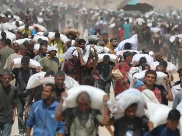 GAZA CITY, GAZA - JULY 27: Palestinians walk for kilometers after receiving flour aid distributed from trucks that entered the Zikim area, a kibbutz in southern Israel, amid ongoing Israeli attacks and severe food shortages, in Gaza City, Gaza, on July 27, 2025. Mahmoud Issa  / AnadoluNo Use USA No use UK No use Canada No use France No use Japan No use Italy No use Australia No use Spain No use Belgium No use Korea No use South Africa No use Hong Kong No use New Zealand No use Turkey