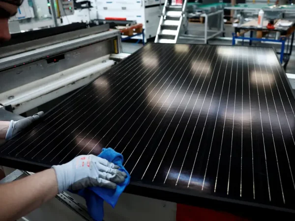 FILE PHOTO: An employee works on a solar panel production line at the Systovi factory in Carquefou near Nantes, France, March 29, 2024. REUTERS/Stephane Mahe/File Photo
