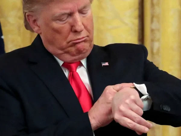 FILE PHOTO: U.S. President Donald Trump checks his watch during an event to celebrate federal judicial confirmations in the East Room of the White House in Washington, D.C., U.S., November 6, 2019. REUTERS/Jonathan Ernst/File Photo
