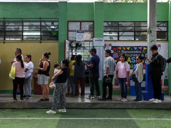 People queue to vote at a polling station after Peru's general election was extended to a second day in some precincts of the capital due to the late setup of voting tables and the absence of citizens assigned to receive voters, in Lima, Peru, April 13, 2026. REUTERS/Manuel Orbegozo