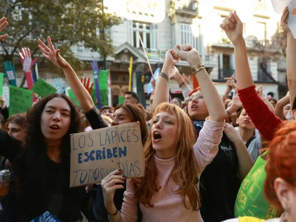 A demonstrator holds a sign that reads