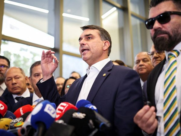 Flavio Bolsonaro speaks with members of the press after a meeting, following a scandal over messages tied to his request for funding for a biopic about former Brazilian President Jair Bolsonaro, from disgraced banker Daniel Vorcaro, who was arrested in March on suspicion of leading a multibillion-dollar fraud scheme, in Brasilia, Brazil, May 19, 2026. REUTERS/Mateus Bonomi