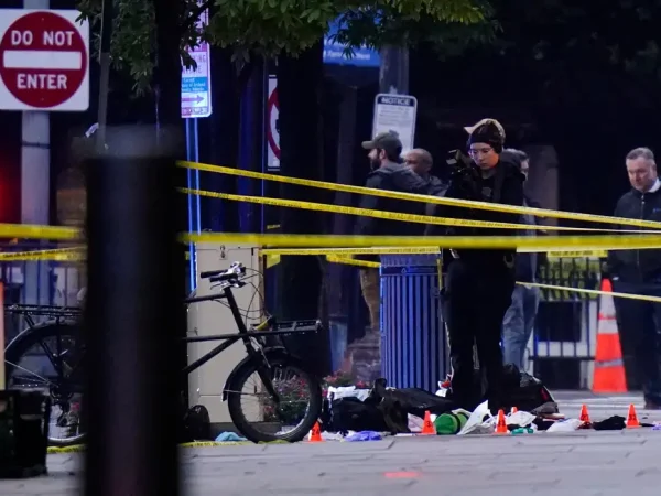 A member of law enforcement takes photographs in a cordoned-off area near the White House after a shooting incident in Washington, D.C., U.S., May 23, 2026. REUTERS/Nathan Howard     TPX IMAGES OF THE DAY