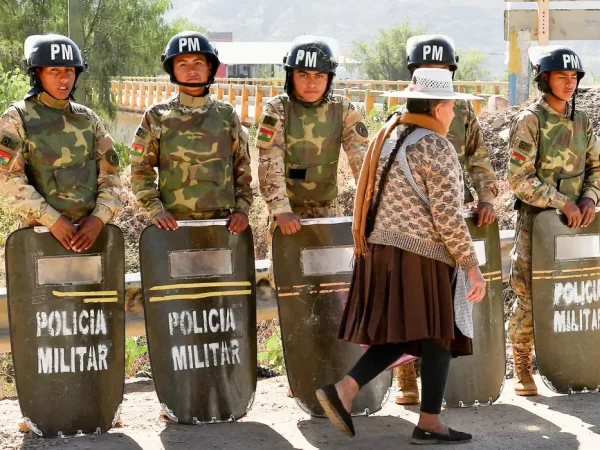 Military personnel stand in formation as they are deployed, while a woman walks past in front of them, after Bolivian President Rodrigo Paz declared a nationwide state of emergency following weeks of violence and blockades,  in Cochabamba, Bolivia, June 20, 2026. REUTERS/Patricia Pinto

     TPX IMAGES OF THE DAY