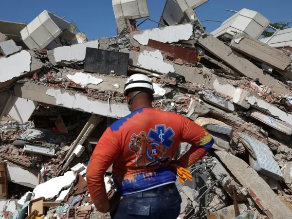 A member of Civil Protection looks at rubble of a collapsed building in the aftermath of the June 24 earthquakes in La Guaira, Venezuela, July 1, 2026. REUTERS/Ricardo Arduengo