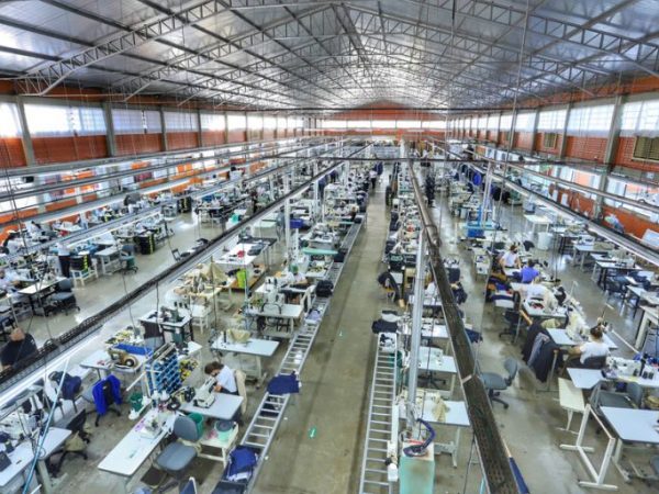 Pessoas trabalhando em fábrica de roupas