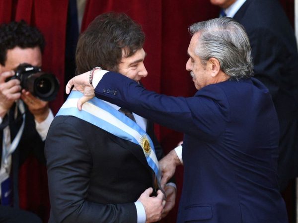 Outgoing Argentine President Alberto Fernandez passes the presidential sash to Javier Milei after he was sworn in as Argentina's next president, in Buenos Aires, Argentina December 10, 2023. REUTERS/Matias Baglietto