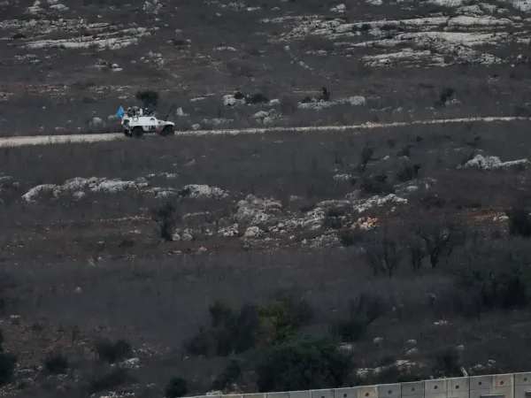 A UN vehicle drives near a concrete wall along Lebanon's southern border which, according to the Lebanese presidency, extends beyond the