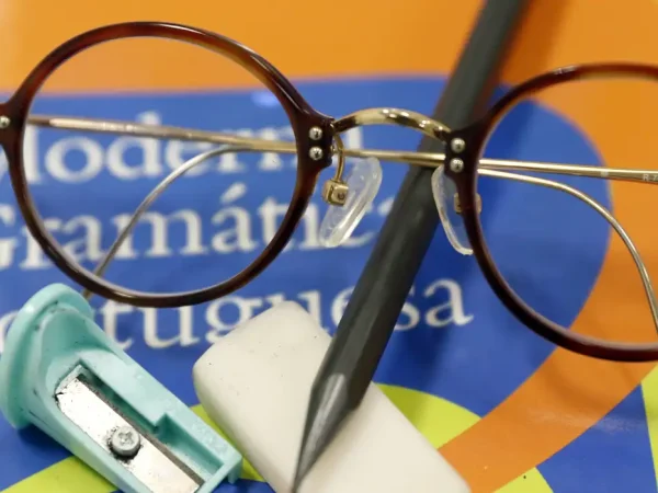 Brasília (DF), 07/02/2025 - Saúde ocular de alunos pede atenção na volta às aulas. Óculos em cima de gramática com lápis, borracha e apontador. Foto: Bruno Peres/Agência Brasil