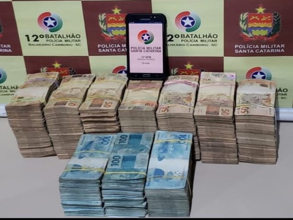 Policiais encontraram dinheiro escondido dentro de uma sacola. Três pessoas foram detidas em Balneário Camboriú — Foto: PM/Divulgação.